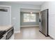 Kitchen dining area with a window overlooking the yard and stainless steel refrigerator at 1341 Springdale St, Clearwater, FL 33755