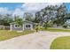 Gray house with white trim, landscaping, and a paved driveway at 1341 Springdale St, Clearwater, FL 33755