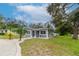 Newly renovated gray house with landscaping and a curved driveway at 1341 Springdale St, Clearwater, FL 33755