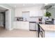 Updated kitchen with white cabinets, granite countertops, and stainless steel appliances at 1341 Springdale St, Clearwater, FL 33755