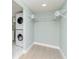 Laundry closet with stackable washer and dryer and wire shelving at 1341 Springdale St, Clearwater, FL 33755