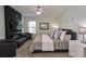 Main bedroom with a king-size bed and fireplace at 15415 Trinity Fall Way, Bradenton, FL 34212