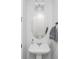 Small bathroom with pedestal sink, oval mirror, and gray towels at 1608 Sunset Wind Loop, Oldsmar, FL 34677
