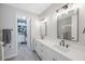 Modern bathroom with double vanity, walk-in shower, and large mirror at 1608 Sunset Wind Loop, Oldsmar, FL 34677