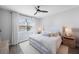Bright bedroom with ceiling fan, large bed, and wood nightstand at 1608 Sunset Wind Loop, Oldsmar, FL 34677