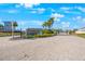 Bayside Terrace community entrance with paved road, landscaping, and signage at 1608 Sunset Wind Loop, Oldsmar, FL 34677