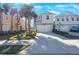 Two-story townhome with white garage door and palm trees at 1608 Sunset Wind Loop, Oldsmar, FL 34677