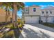 Two-story townhome with white garage door and landscaping at 1608 Sunset Wind Loop, Oldsmar, FL 34677