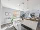 Modern kitchen island with white cabinets and stainless steel dishwasher at 1608 Sunset Wind Loop, Oldsmar, FL 34677