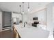 Modern kitchen with white cabinets, large island, and stainless steel appliances at 1608 Sunset Wind Loop, Oldsmar, FL 34677