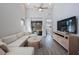 Living area featuring sectional sofa and hardwood floors at 1608 Sunset Wind Loop, Oldsmar, FL 34677