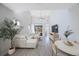 Bright living room with sectional sofa, round table, and hardwood floors at 1608 Sunset Wind Loop, Oldsmar, FL 34677