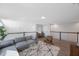 Open loft living space, featuring a sectional sofa and hardwood floors at 1608 Sunset Wind Loop, Oldsmar, FL 34677