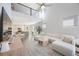 Open living space with sectional sofa, high ceilings, and kitchen view at 1608 Sunset Wind Loop, Oldsmar, FL 34677