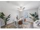 Bright home office with a desk, treadmill, and large plants at 1608 Sunset Wind Loop, Oldsmar, FL 34677