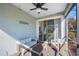 Relaxing screened porch with outdoor furniture and ceiling fan at 1608 Sunset Wind Loop, Oldsmar, FL 34677