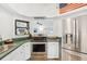 Stainless steel appliances and green countertops in this well-lit kitchen at 1708 Dove Field Pl, Brandon, FL 33510