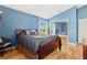 Bright bedroom with wood floors and a mirrored closet at 18119 Diamond Cove Ct, Tampa, FL 33647