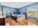 Bedroom with wood floors, window, and built-in shelving at 18119 Diamond Cove Ct, Tampa, FL 33647