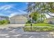 Two-story house with a three-car garage and lush landscaping at 18119 Diamond Cove Ct, Tampa, FL 33647