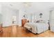 Bright main bedroom featuring hardwood floors and ensuite bathroom at 18119 Diamond Cove Ct, Tampa, FL 33647