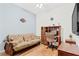 Home office with wood desk, comfortable futon, and hardwood floors at 18119 Diamond Cove Ct, Tampa, FL 33647