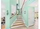 Light and airy staircase with wood steps and mint walls at 18119 Diamond Cove Ct, Tampa, FL 33647