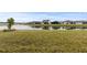 Waterfront homes with lush green grass and a serene lake view at 19771 Ship Wheel Way, Land O Lakes, FL 34638