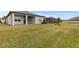 Spacious backyard with grassy area and a view of the pond at 19771 Ship Wheel Way, Land O Lakes, FL 34638