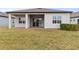 House backyard with covered patio and grassy area at 19771 Ship Wheel Way, Land O Lakes, FL 34638