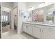 Spacious bathroom with double sinks, granite countertops, and a walk-in shower at 19771 Ship Wheel Way, Land O Lakes, FL 34638