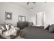 Bedroom with dark dresser and a comfortable chaise lounge at 19771 Ship Wheel Way, Land O Lakes, FL 34638