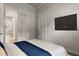 Guest bedroom with a comfortable bed, TV, and access to the kitchen at 19771 Ship Wheel Way, Land O Lakes, FL 34638