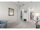 Bright bedroom with a sitting area, mirror, and access to bathroom at 19771 Ship Wheel Way, Land O Lakes, FL 34638