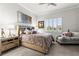 Main bedroom with plush bedding and seating area at 19771 Ship Wheel Way, Land O Lakes, FL 34638