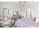 Bedroom with dresser, seating area and patterned bedding at 19771 Ship Wheel Way, Land O Lakes, FL 34638