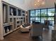 Modern and stylish common area with comfortable seating and built-in shelving at 19771 Ship Wheel Way, Land O Lakes, FL 34638
