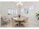 Bright dining room with round table and six chairs, featuring a chandelier at 19771 Ship Wheel Way, Land O Lakes, FL 34638