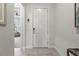 Clean entryway with white door, gray walls, and tile flooring at 19771 Ship Wheel Way, Land O Lakes, FL 34638
