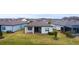 Rear view of home showcasing patio and landscaping at 19771 Ship Wheel Way, Land O Lakes, FL 34638