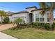 One-story house with gray siding, brown roof, and a brick paver driveway at 19771 Ship Wheel Way, Land O Lakes, FL 34638