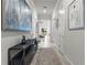 Bright and airy hallway with modern console table and artwork at 19771 Ship Wheel Way, Land O Lakes, FL 34638