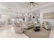 Open concept living room and kitchen with neutral tones and modern furnishings at 19771 Ship Wheel Way, Land O Lakes, FL 34638