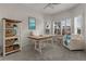 Home office with built-in shelving, desk, and comfortable seating at 19771 Ship Wheel Way, Land O Lakes, FL 34638