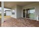 Covered patio with sliding glass doors leading to interior at 19771 Ship Wheel Way, Land O Lakes, FL 34638