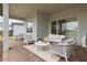 Relaxing covered patio with wicker furniture and paver floor at 19771 Ship Wheel Way, Land O Lakes, FL 34638