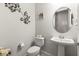Powder room with pedestal sink and decorative accents at 19771 Ship Wheel Way, Land O Lakes, FL 34638