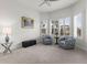 Cozy sitting area with two armchairs, a side table, and large windows at 19771 Ship Wheel Way, Land O Lakes, FL 34638