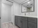 Modern bathroom with gray vanity, quartz countertop, and a large mirror at 220 Belleview Blvd # 607, Belleair, FL 33756