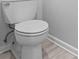 Standard toilet and light gray vinyl flooring at 220 Belleview Blvd # 607, Belleair, FL 33756